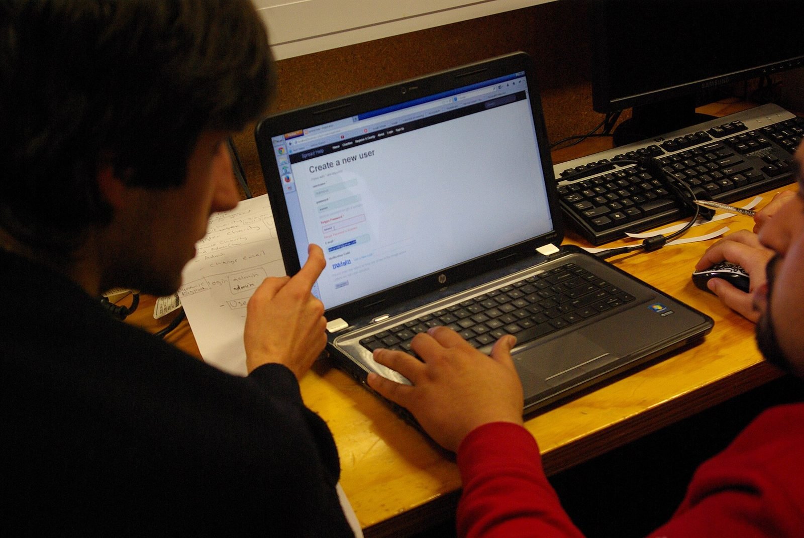 A developer writing code on a laptop